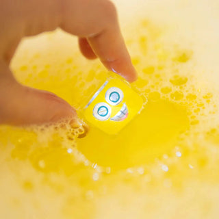 A yellow bath light cube in bath water