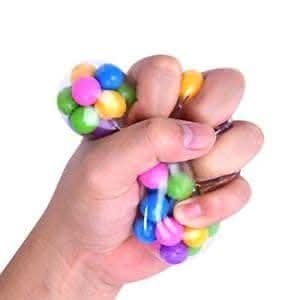 Person squeezing DNA Stress Ball for tactile stress relief