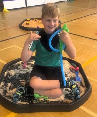 Autistic child exploring sensory toys designed to support sensory development and emotional regulation