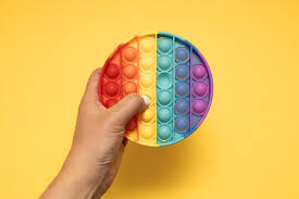 adult playing with a pop it fidget toy for adhd