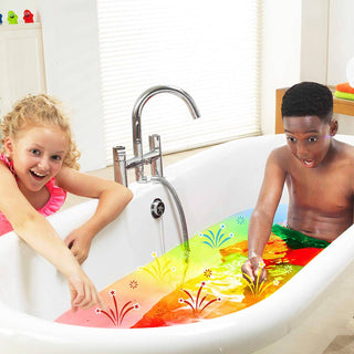 Child in a rainbow coloured water bath of crackle baff.