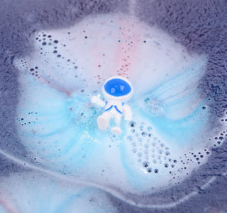 Zimpli Alien bath bomb with toy inside fizzing in colourful bath water